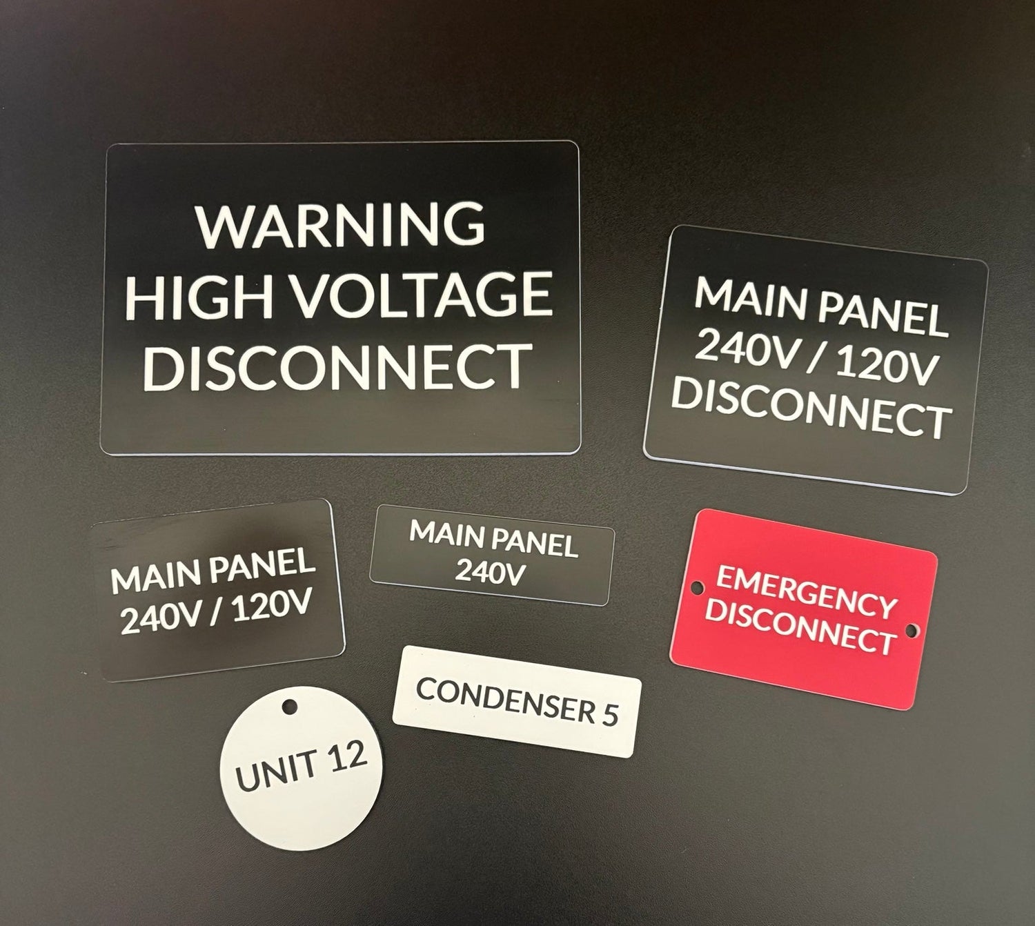 Custom engraved electrical panel labels made from two-tone acrylic for breaker boxes, disconnect switches, meters, and equipment identification