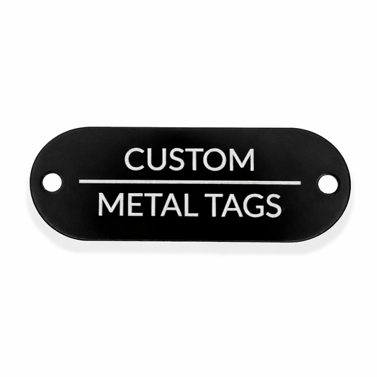 Black metal tag with 'Custom Metal Tags' text on a white background