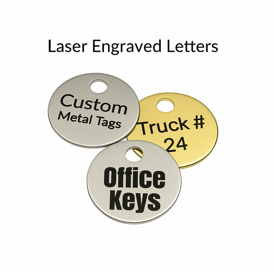 Three custom metal tags with laser engraved text on a white background